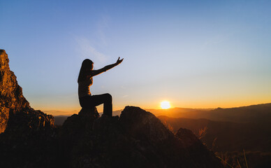 Silhouette of christian woman hand praying,spirituality and religion,man praying to god. Christianity concept.   Freedom and travel adventure.