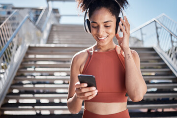 Sticker - Fitness, music headphones and black woman with phone for social media in city. Sports, exercise and female athlete streaming song, radio or podcast on 5g mobile smartphone after training outdoors.