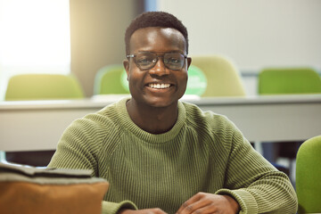 Aufkleber - Black man, student and portrait in classroom for education, study and happy at college with smile. African gen z learner, class and desk at university for goals, learning and motivation for future