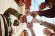 © S Fanti/peopleimages.com - Below, students and fist hands in group for support, motivation or education in sunshine at college. Diversity, fist bump and community with teamwork, studying or scholarship at university for future