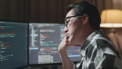 Close Up Of Asian Male Programmer Being Bored Creating Software Engineer Developing App, Program, Video Game On Desktop Computer At Home. Terminal With Coding Language 
