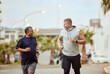 © S Fanti/peopleimages.com - Running, friends and senior men in city for fitness, healthy lifestyle and outdoor wellness. Happy mature males, urban training and exercise in street for energy, power and sports workout together