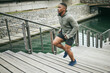 © S Fanti/peopleimages.com - Fitness, runner or black man running on stairs for legs training, exercise or workout in city of in Miami, Florida. Steps, bridge or healthy sports athlete with wellness goals, motivation or mission