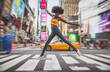 Leinwandbild Motiv Young beautiful girl walking in Time square, manhattan. Lifestyle concepts about New york