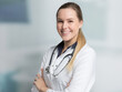 young female doctor with stethoscope looking friendly