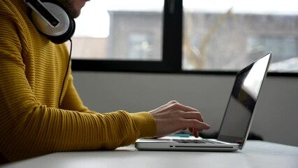 Wall Mural - Young man freelancer entrepreneur using laptop online working from home, surfing web looking at screen enjoying distant job