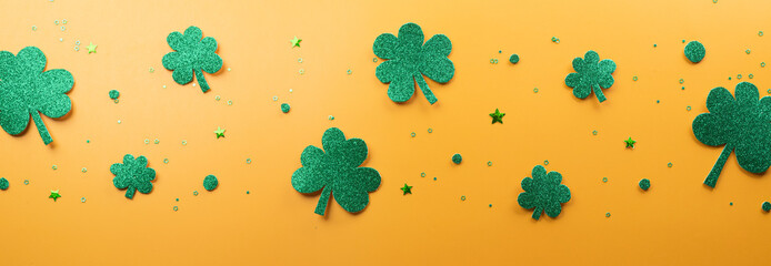 Wall Mural - Happy St Patrick's Day decoration concept made from shamrocks ( clover leaf) and leprechaun hat on yellow background.