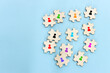Business image of wooden puzzle with people icons over blue background, human resources and management concept