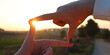 Leinwandbild Motiv woman's hand creates a frame in front of the sun. idea of vision and focus