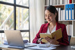 © wichayada - Smile Pretty business Asian woman is working her job on a laptop computer in a modern office. Doing accounting analysis report real estate investment data, Financial and tax systems concept