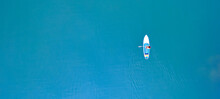 Woman Rowing Oar On Sup Board Blue Sea Water. Aerial Top View Paddleboard Banner
