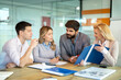 © Bojan - Group of business people discussing together business document during the meeting in office