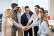 © Bojan - Success business team showing unity with their hands together at office