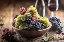 Juicy Bunches Of Grapes In A Wooden Bowl, Red Wine In The Background