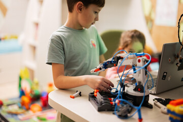 children learning repairing getting lesson control robot arm, robotic machine arm in home workshop, 