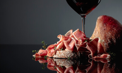 Wall Mural - Prosciutto with ciabatta, red wine and thyme.