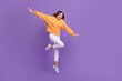 © deagreez - Full length portrait of cheerful excited girl jumping have fun empty space isolated on purple color background