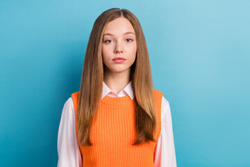 Wall Mural - Photo portrait of young teen serious face schoolgirl wear cute uniform orange cardigan with shirt look you isolated on blue color background