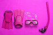 Leinwandbild Motiv Diving mask with snorkel and fins on pink background. Vacation at sea, travel concept. Top view