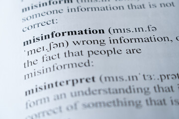 A mock up of a dictionary page with the word misinformation with selective focussing