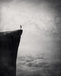 © psychoshadow - Freedom and liberty conceptual scene. Man on the edge of a cliff self liberating from fears and doubts as a flock of birds escape his body and fly free in the air. Surreal and inspirational art