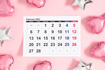 Valentine's Day background. Date February 14 on calendar 2023,  heart-shaped balloon on pink background. Valentines Day. Balloon Heart. Flat lay, top view, copy space 