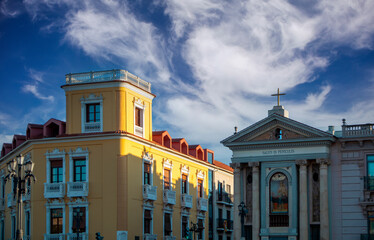 Sticker - View of a street in Murcia, Spain, where you can see a unique yellow building and a shrine or niche with the Virgen de los Peligros