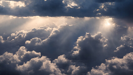 Wall Mural - an aerial shot above beautiful cloudscape with sun rays coming through the clouds, detailed pictures