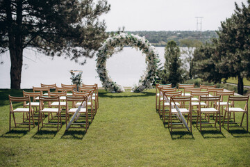Wall Mural - wedding ceremony arch with empty chairs and flowers. beautiful romantic decoration