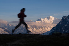 A Silhouette Of A Woman Running In The French Alps Near Chamonix, France.