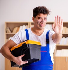 Wall Mural - Funny Man doing electrical repairs at home