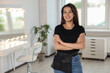 © New Africa - Portrait of happy hairdresser with professional tools in beauty salon. Space for text