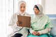 © Art_Photo - Muslim asian woman doctor service help support discussing and consulting talk to muslim woman patient at meeting health medical care express trust concept in hospital.healthcare and medicine