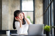 © crizzystudio - Happy Asian woman relaxing and listening to music in office with computer laptop and coffee cup. People and lifestyles concept. Freelance and outdoors workplace outdoors theme.
