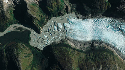  aerial view of glacier between rocky and snowy mountains
