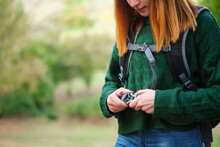 Close Up Of Hiker Redhead Young Woman Fastening Backpack Strap In The Mountain. Trekking Concept.