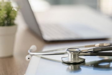 Wall Mural - stethoscope computer and background doctor using laptop at desk medical network on Computing electronic medical