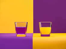 Two Glass Of Orange Juice And Grape Juice On A Checked Background