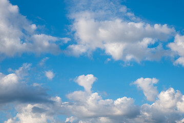 Wall Mural - cloud scape with fluffy cumulus clouds, one in a heart shape