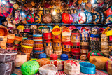 Fototapeta Miasta - Variety of leather poufs sold in huge shop next to tannery in Fes, Morocco,  Africa