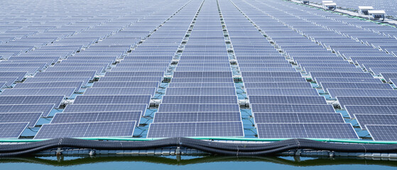 Solar power plant farm on beautifull lake. Floating solar panels providing green energy. Renewable energy.