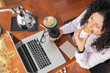 © ADDICTIVE STOCK - Woman with laptop having snack in home office