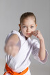 Little girl sparring, punch in karate, close-up portrait.