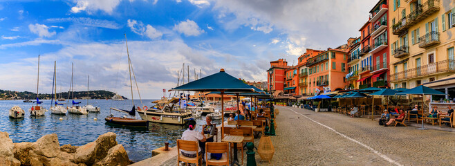 Canvas Print - Seaside promenade with colorful traditional houses along the Mediterranean Sea in Villefranche sur Mer Old Town on the French Riviera, South of France