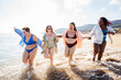© oneinchpunch - Group of beautiful plus size women with swimwear bonding and having fun at the beach - Group of curvy female friends enjoying summertime at the sea, concepts about body acceptance, body positive