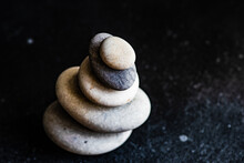 Overhead View Of A Stack Of Pebbles Against A Black Background