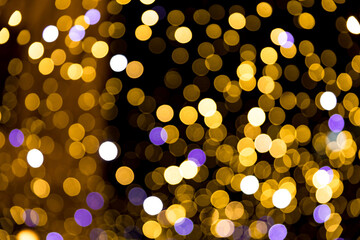 festive christmas night city defocused warm yellow bokeh lights abstract background