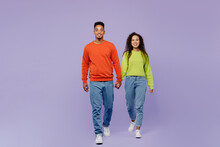 Full Body Front View Young Couple Two Friends Family Man Woman Of African American Ethnicity Wear Casual Clothes Hold Hands Walk Go Strolling Together Isolated On Pastel Plain Light Purple Background.