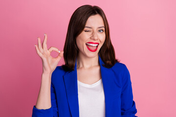 Canvas Print - Photo of young funny blink eye flirty business woman wear blue blazer showing okey sign work done everything cool isolated on pink color background