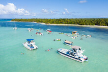 Speed Boats With People Having Fun In Caribbean Sea Near Tropical Island With Palm Trees. Dominican Republic. Aerial View